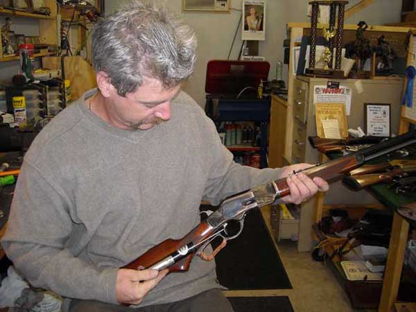 Jimmy measuring the trigger weight on Dead Head's new rifle.