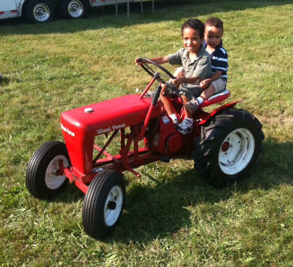 Vance Montana's two sons driving Jimmy's tractor - July 2010' width=