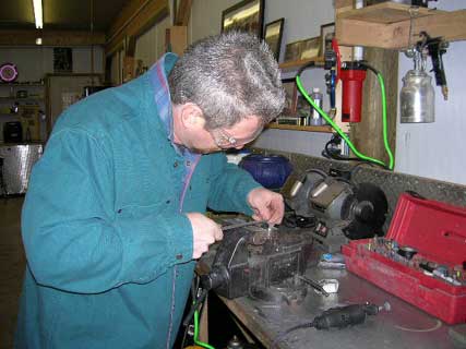 Jimmy Spurs working filing a part.