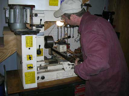 Working on the lathe making a part.